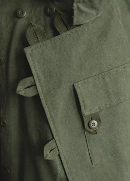 Large chest pocket with button flap on Swedish military motorcycle jacket – functional canvas design.