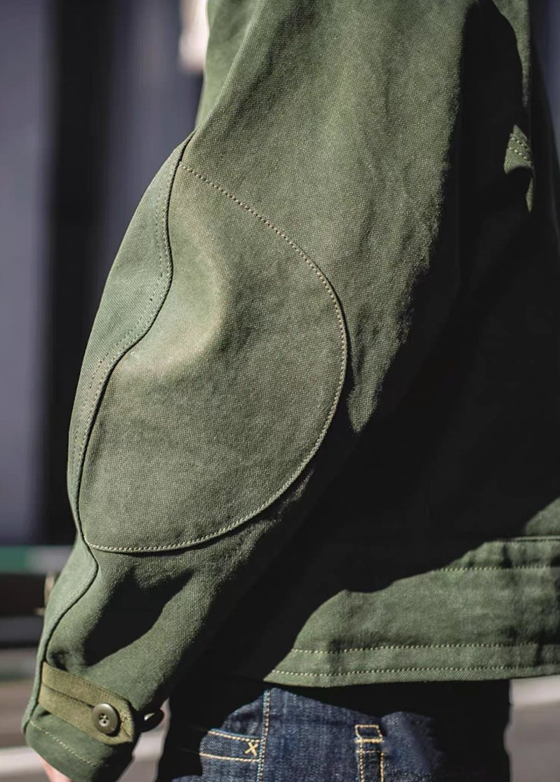 Reinforced elbow patch detail on Swedish military motorcycle jacket – durable canvas construction.
