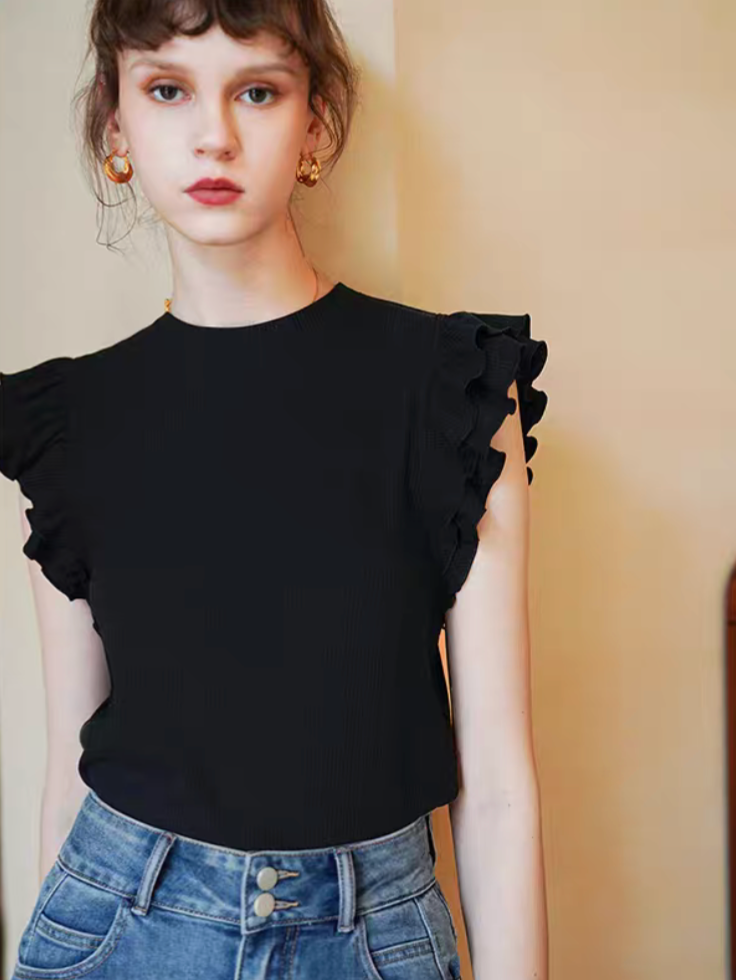 Black ruffle sleeveless fitted top front view with double-layer shoulder ruffles styled with high-waisted jeans