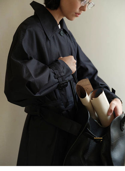 Detail view of Dark Navy Blue Tailored Belted Trench Coat sleeve showing adjustable cuff strap, stitching and refined tailoring