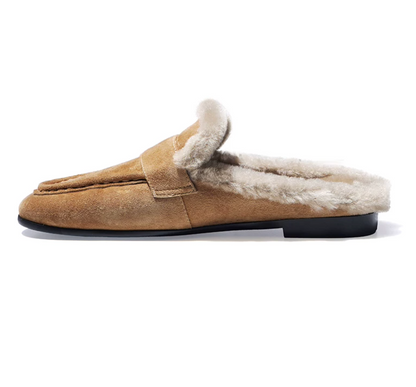 Side profile of a tan suede loafer mule with moc-toe stitching and a 0.6-inch heel