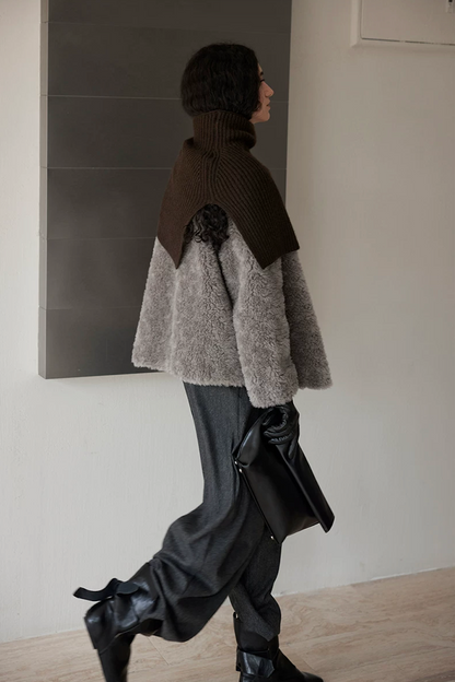 Side view of a Taupe Gray hip-length wool teddy jacket in motion