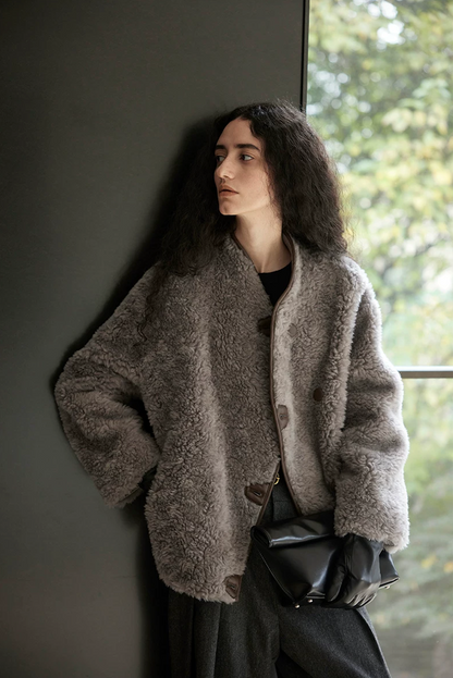 Three-quarter view of a Taupe Gray boxy wool teddy jacket with dropped shoulders