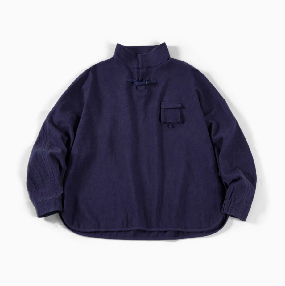 Blue textured cotton polo shirt flat lay front view featuring jacquard fabric, half-placket closure, and chest pocket detail