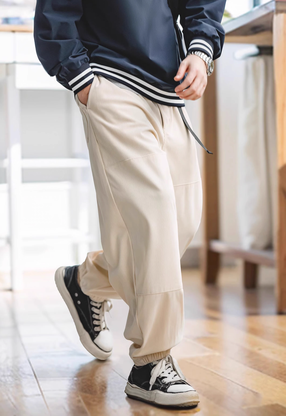 Model walking in Textured Lounge Joggers in Beige featuring soft corduroy fabric, elastic cuffs, relaxed fit, and casual everyday comfort