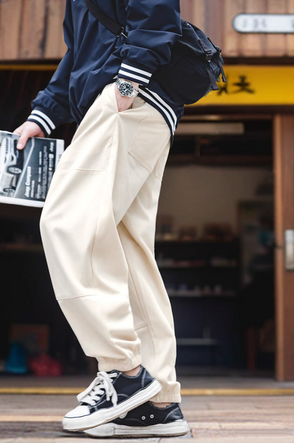 Side angle of Textured Lounge Joggers in Beige highlighting practical pocket design, elastic waistband with belt, and modern streetwear styling