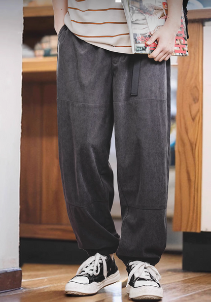 Model wearing Textured Lounge Joggers in Dark Gray featuring corduroy texture, relaxed fit, elastic waistband with belt, and cuffed ankles in indoor setting