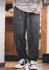 Model wearing Textured Lounge Joggers in Dark Gray featuring corduroy texture, relaxed fit, elastic waistband with belt, and cuffed ankles in indoor setting