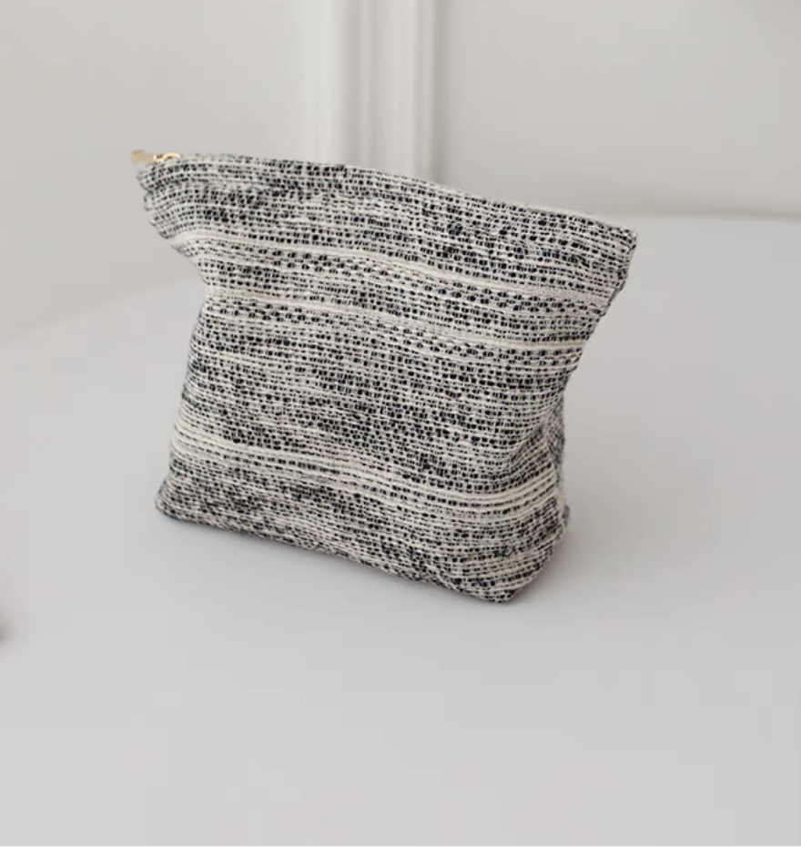 Back view of Textured Stripe Mini Cosmetic Zip Pouch in stripe pattern showing woven textured stripe design