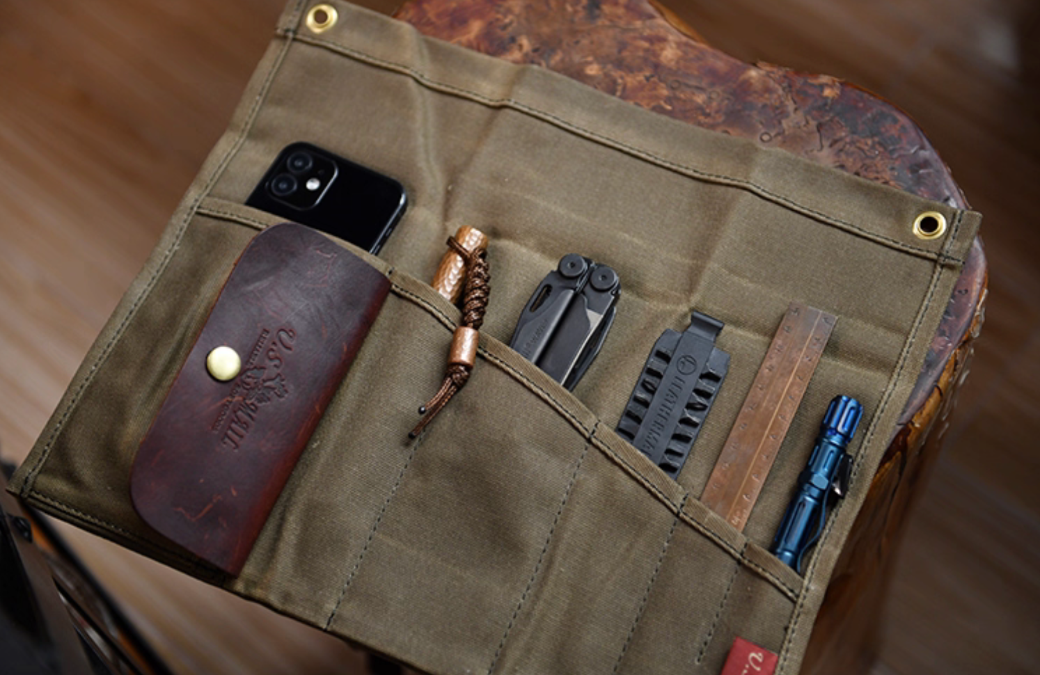 Open army green Field Companion showing phone, tools and ruler in pockets.