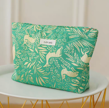 Timeless Elegance Portable Makeup Bag in green little deer pattern placed on round table with botanical design details