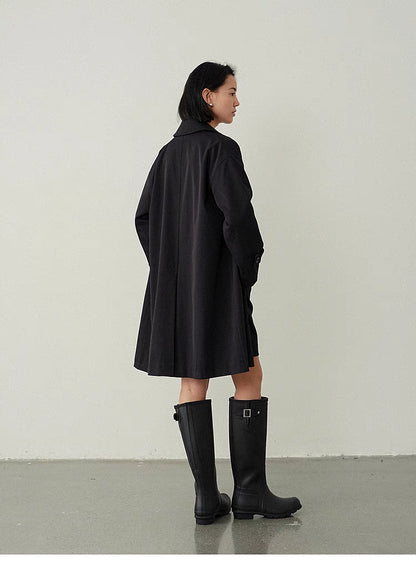 Back view of Black Timeless Trench Coat highlighting clean straight silhouette and mid-length design