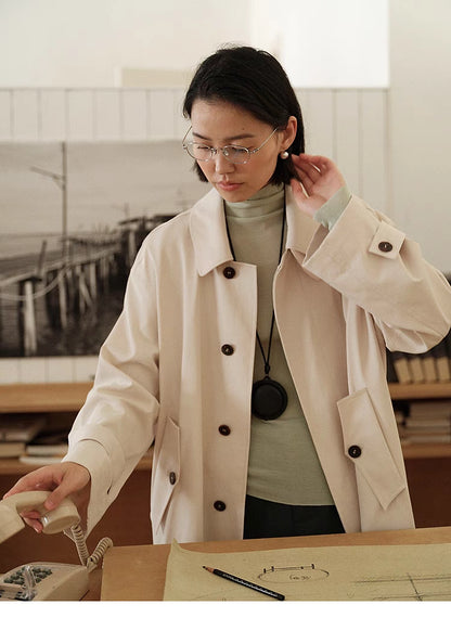 Close-up of Tea Beige Timeless Trench Coat highlighting horn buttons, lapel collar and smooth fabric finish
