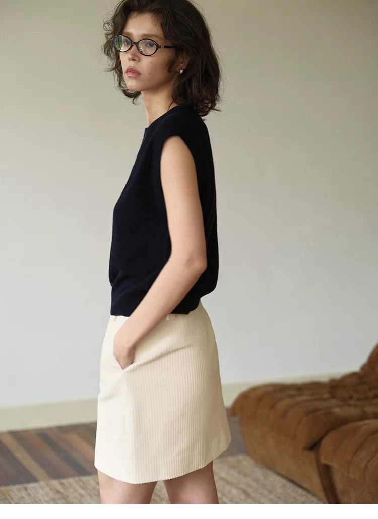 Side view of navy blue Timeless Wool Knit Vest showing clean silhouette, soft wool texture and sleeveless design