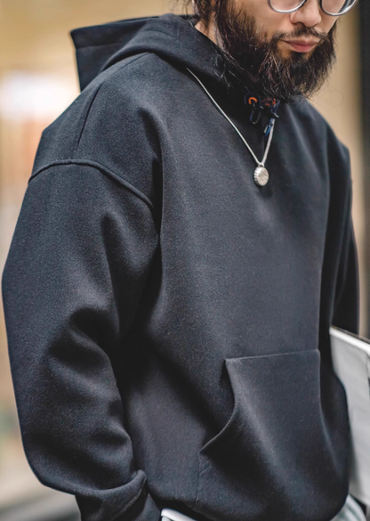 Close-up of model wearing Trailblazer Pullover Hoodie in black highlighting soft fabric texture and relaxed fit