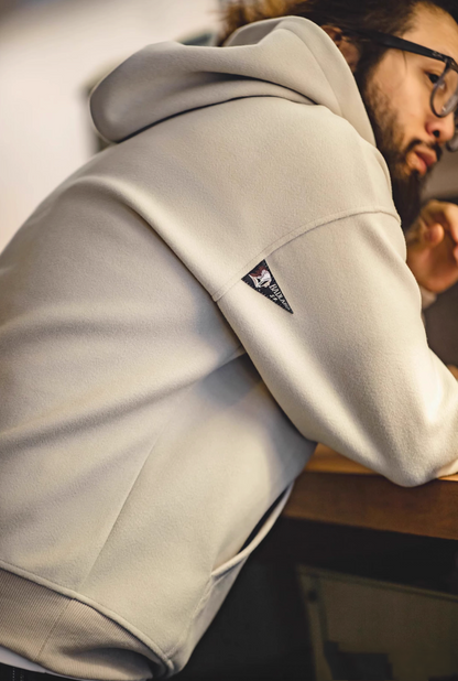 Close-up of Trailblazer Pullover Hoodie in khaki showing side back shoulder and hood with label detail