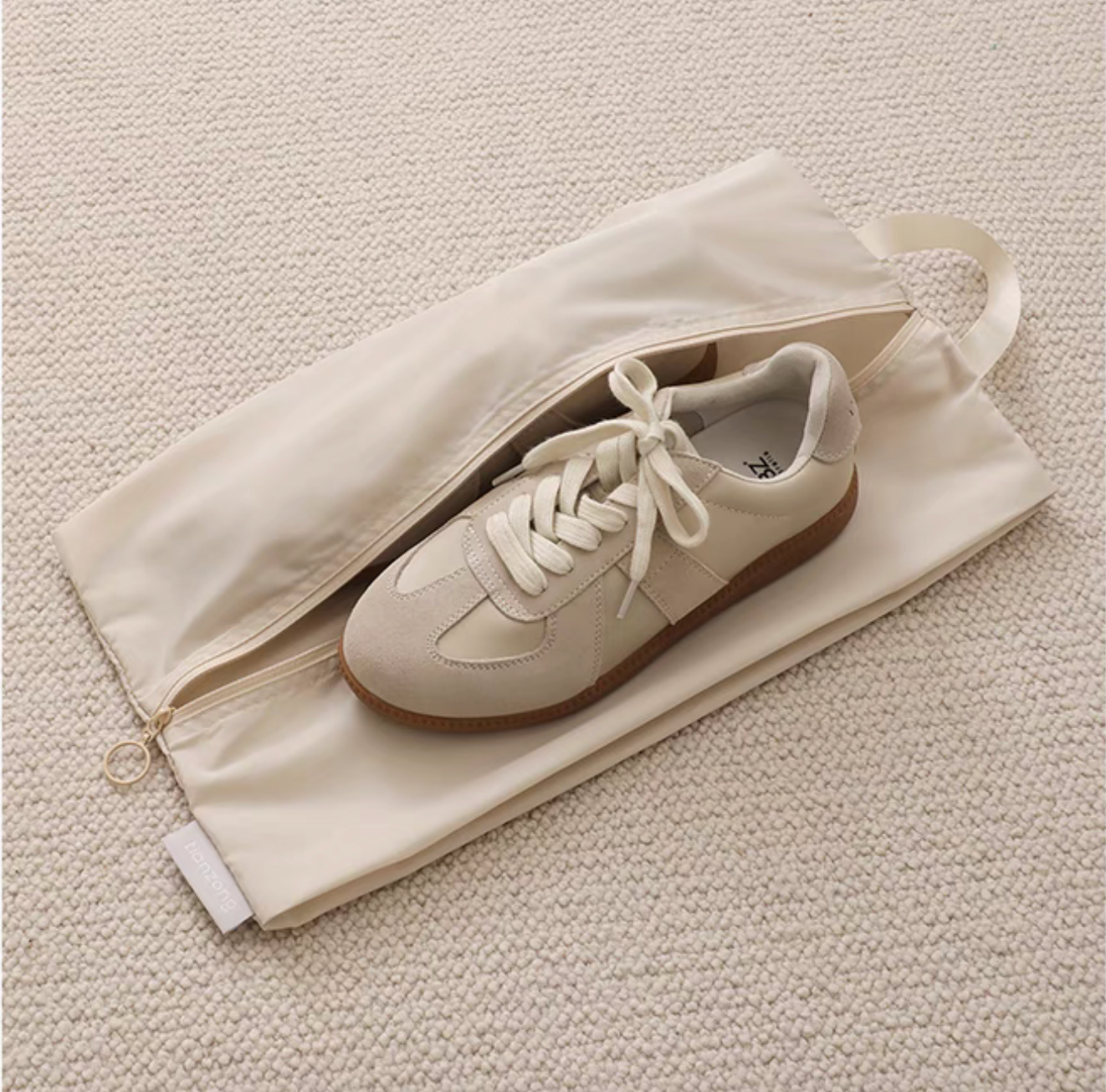 Travel Shoe Dust Bag in beige color with single sneaker inside highlighting zipper closure and dust-proof protection
