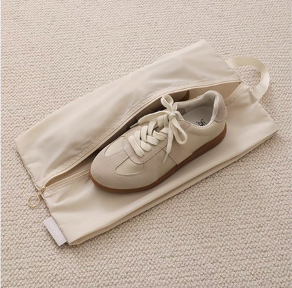 Travel Shoe Dust Bag in beige color with single sneaker inside highlighting zipper closure and dust-proof protection