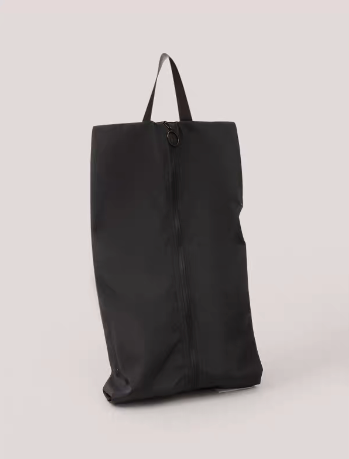 Travel Shoe Dust Bag in black color standing upright with sleek design zipper closure and convenient top handle