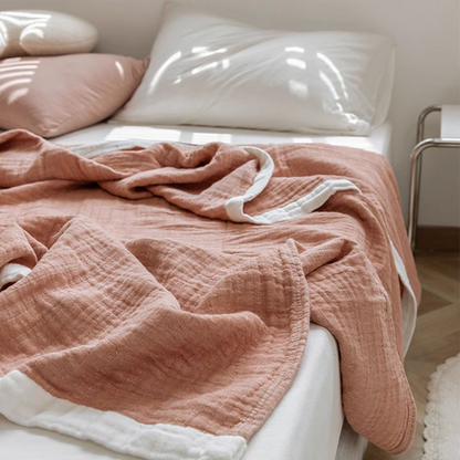 Close-up of deep pink ripple gauze cotton quilt showing soft breathable three-layer cotton texture.