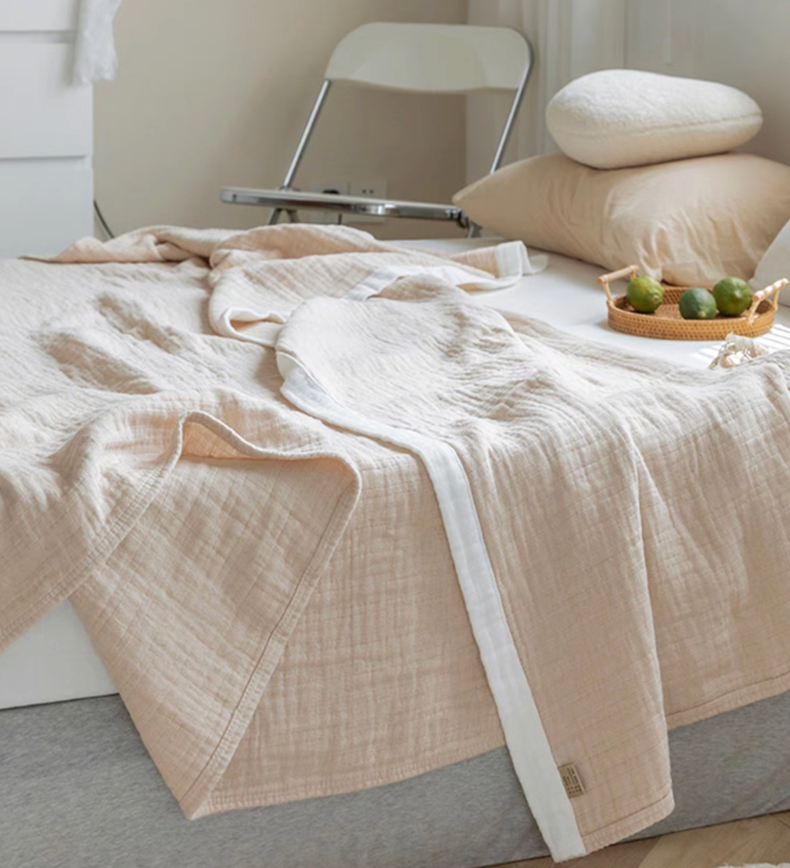 Light brown triple layer gauze cotton quilt close-up showing soft rippled fabric and zigzag edging.