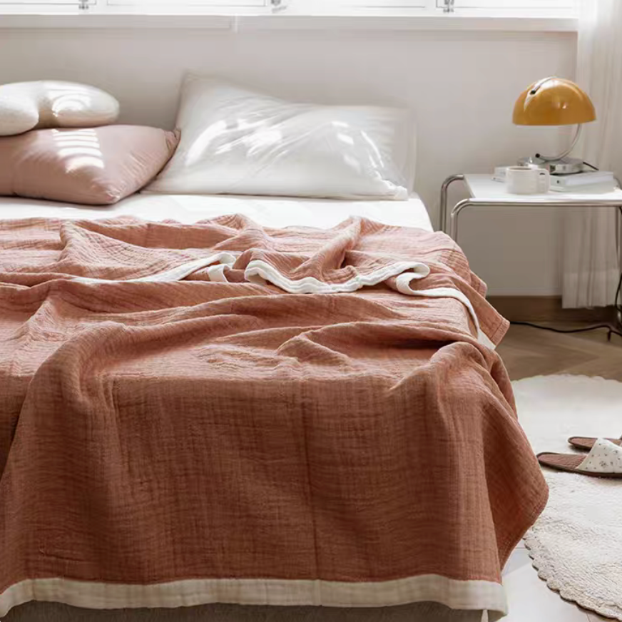 Purple ripple gauze cotton quilt with zigzag edge displayed on minimalist bedroom bed.