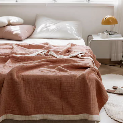 Purple ripple gauze cotton quilt with zigzag edge displayed on minimalist bedroom bed.
