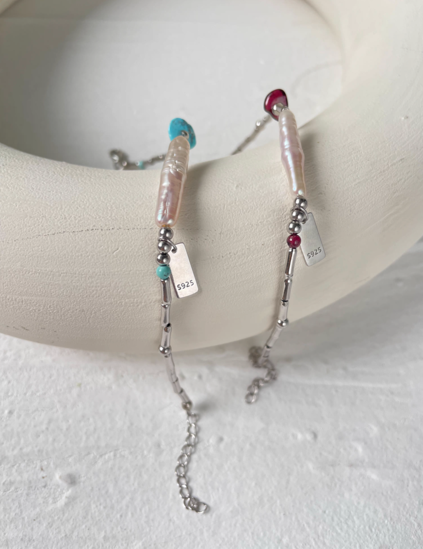 Turquoise baroque pearl bracelet with natural freshwater pearl and silver chain featuring turquoise accent detail on display