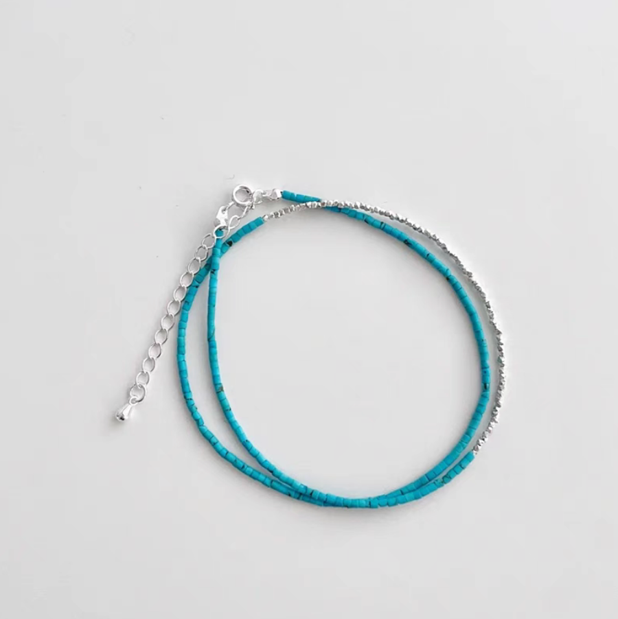 Full view of turquoise and silver delicate choker necklace with adjustable clasp and natural turquoise bead design