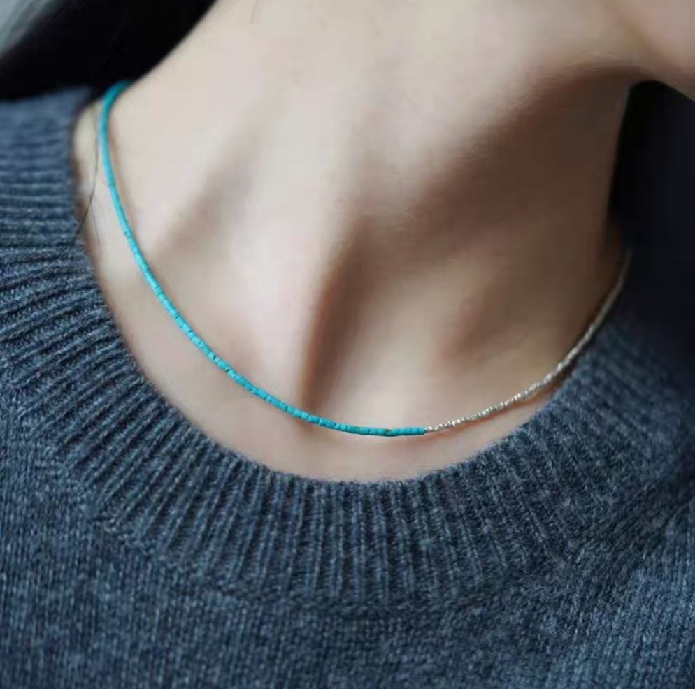 Turquoise and silver delicate choker necklace worn on neck with minimalist turquoise beads and silver chain detail
