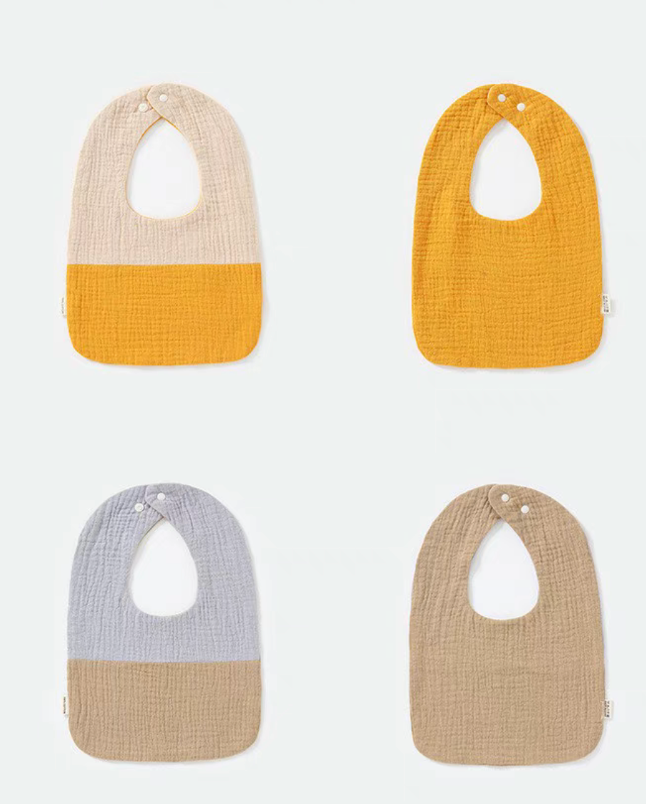 U-neck cotton gauze baby bibs mixed set overview with solid color-block designs in multiple khaki, gray, and orange tones