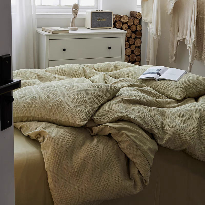 Spring green waffle weave organic cotton bedding set draped naturally on modern bed with breathable cotton texture