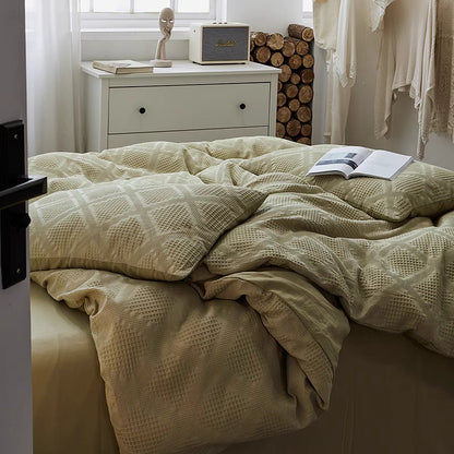Spring green waffle weave organic cotton bedding set draped naturally on modern bed with breathable cotton texture