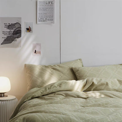 Spring green ultra-soft organic cotton waffle weave bedding set styled in minimalist bedroom with textured duvet cover