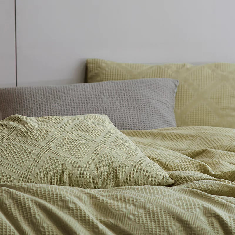 Spring green organic cotton waffle weave duvet cover close-up showing soft breathable textured cotton weave