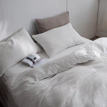 White waffle weave organic cotton duvet cover and pillow shams viewed from above showing breathable textured fabric