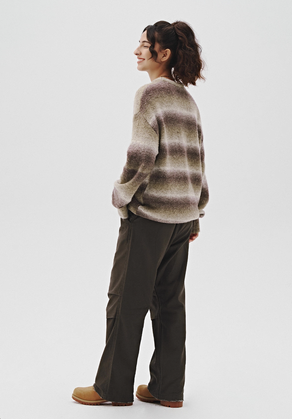 Back view of unisex ombre knit sweater in sage-grey with brushed gradient stripes, relaxed drop shoulder fit.