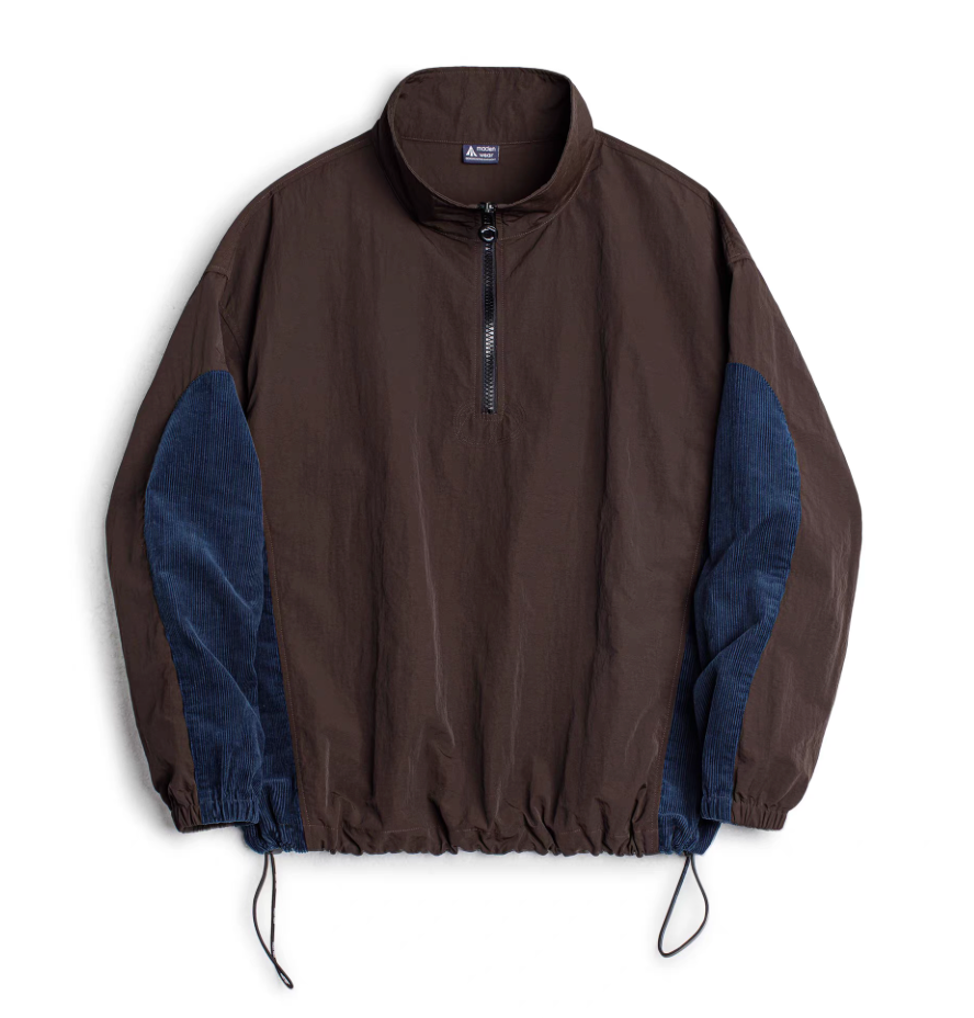 Front flat-lay of URBANCORE dark coffee brown half-zip nylon pullover jacket with navy corduroy side panels and adjustable drawcord hem.