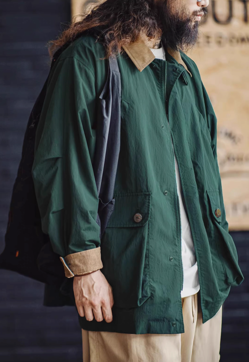 Side view of Dark Green Utility Field Jacket worn with shoulder bag highlighting relaxed fit, sleeve detail and urban style