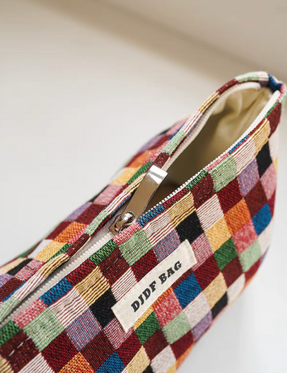 Close-up of small Vibrant Checkered Travel Makeup Bag in multi-colored checkered pattern showing zipper and fabric texture detail