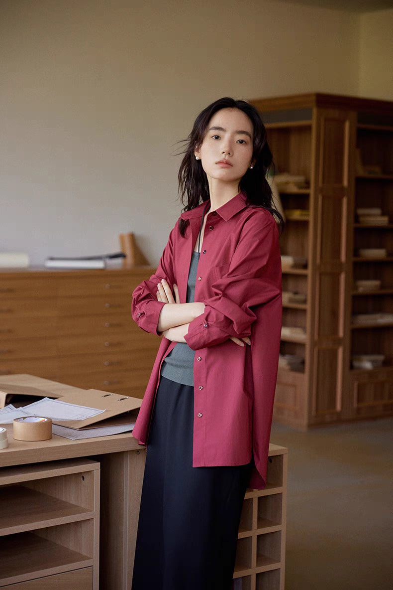 Woman wearing burgundy Vintage Air-Washed Cotton Shirt with arms crossed, showing structured cotton fabric, relaxed fit, and vintage styling