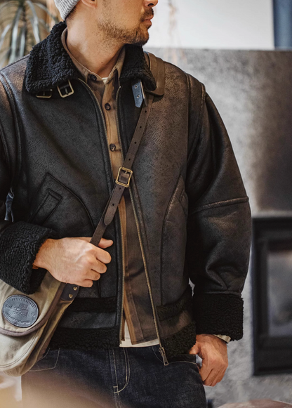 Man wearing Vintage-Inspired Faux Sherpa B3 Bomber Jacket in Black with shoulder bag showing sherpa collar and zip front design