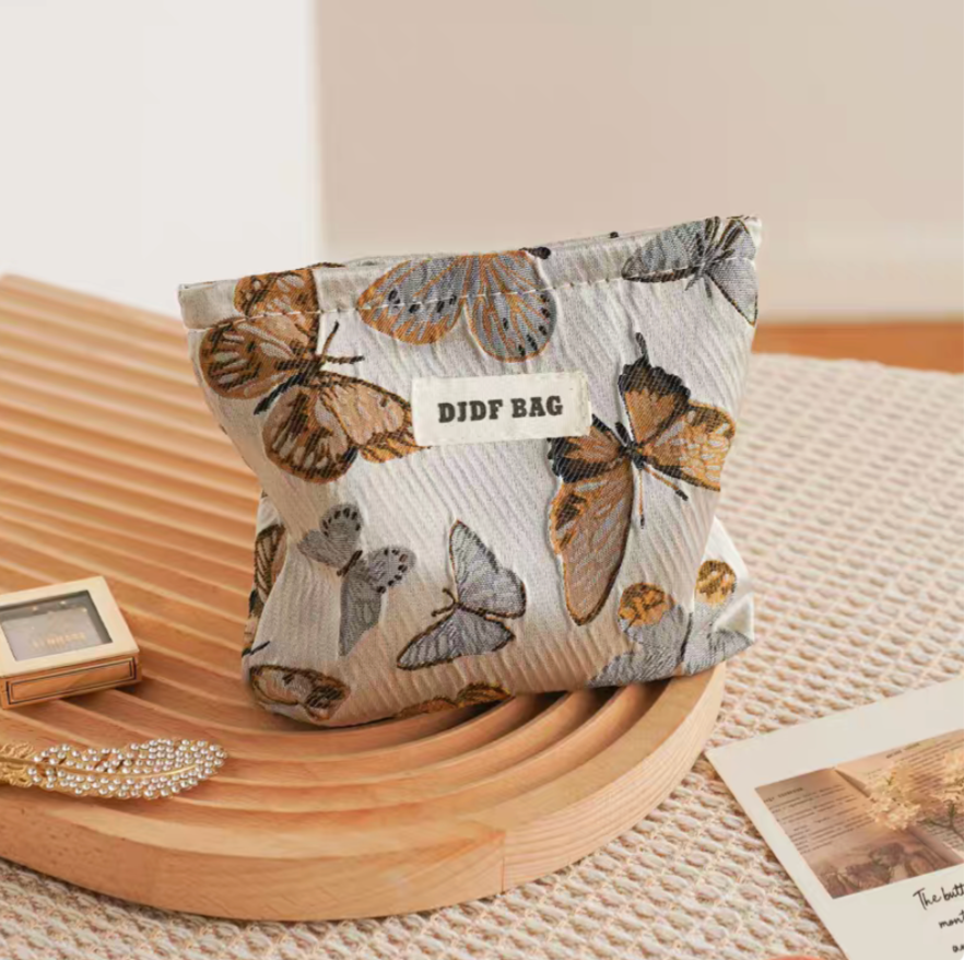 Vintage Butterfly Pattern Portable Makeup Bag in vintage butterfly print upright showing detailed butterfly pattern and fabric texture