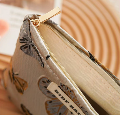Close-up of Vintage Butterfly Pattern Portable Makeup Bag in vintage butterfly print showing zipper and inner lining detail