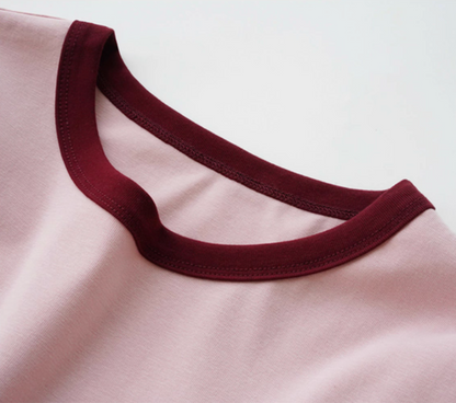 Close-up of Vintage French Contrast Collar Tee in pink with red trim highlighting crewneck stitching and contrast collar detail