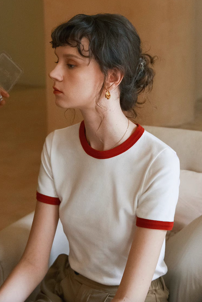Side profile of model in Vintage French Contrast Collar Tee white with red trim highlighting fitted shape and contrast collar detail