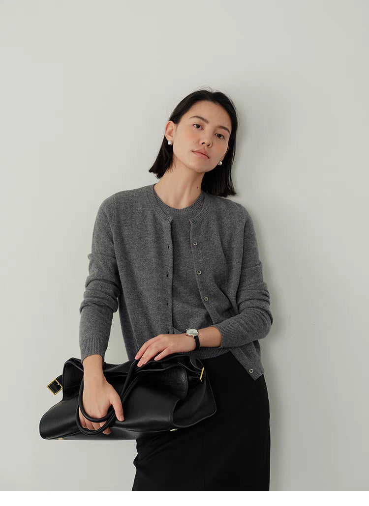 Gray Vintage-Inspired Wool Cardigan styled with black leather bag, modern minimal outfit with soft wool knit