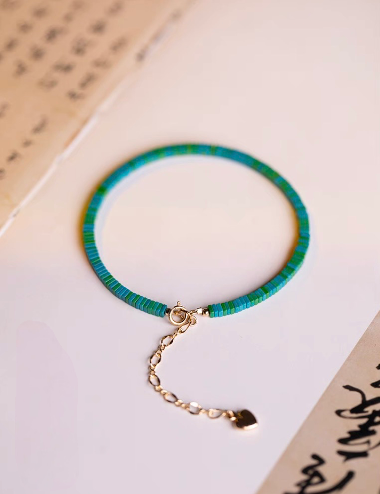 Dark green malachite bracelet full view with gold clasp and extension chain on display