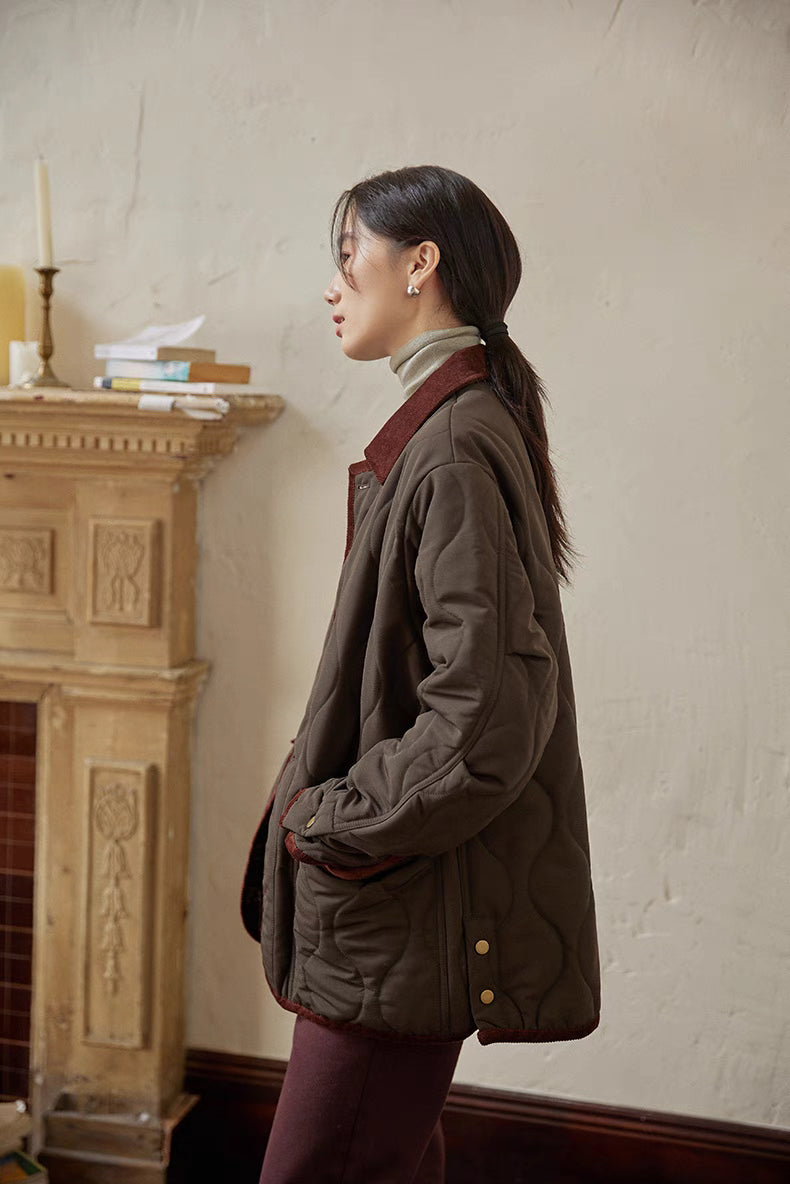 Side profile of Vintage Meadow Jacket in dark brown green highlighting diamond quilting, brass snap details, and straight fit design