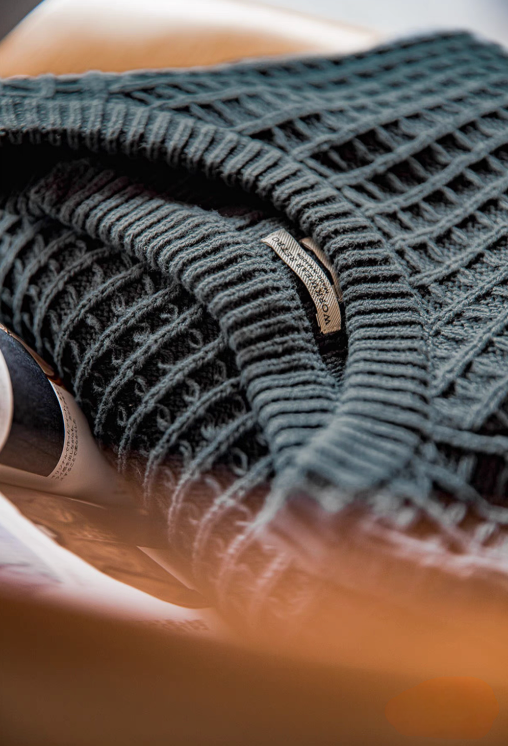 Close-up of Waffle Knit Crewneck Sweater dark green showcasing intricate waffle weave texture and soft knit fabric